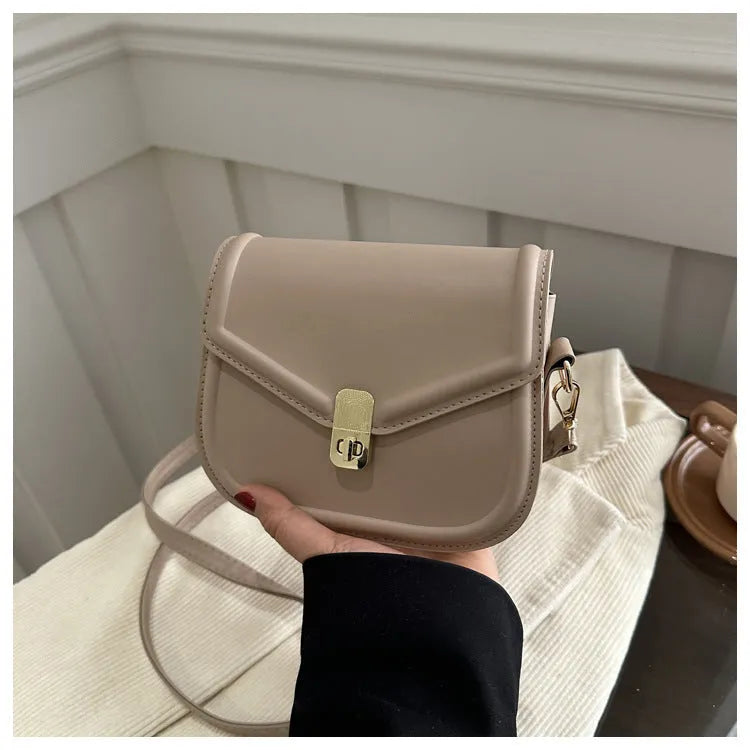 Soft PU leather messenger bag with clamshell opening shown in horizontal square shape on a shoulder strap.