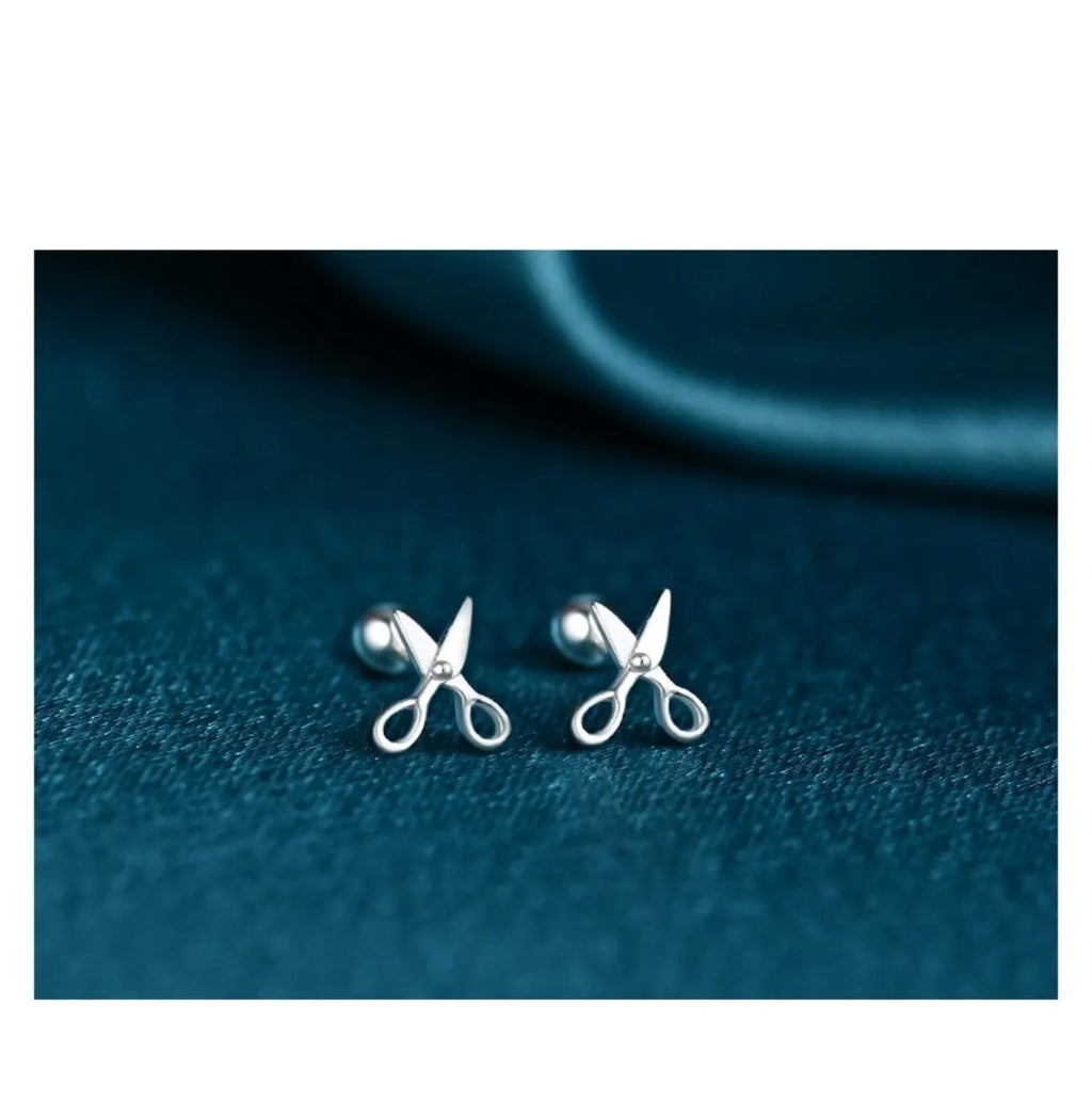 Sterling silver ear nail earrings with screw closure and miniature scissors charm.