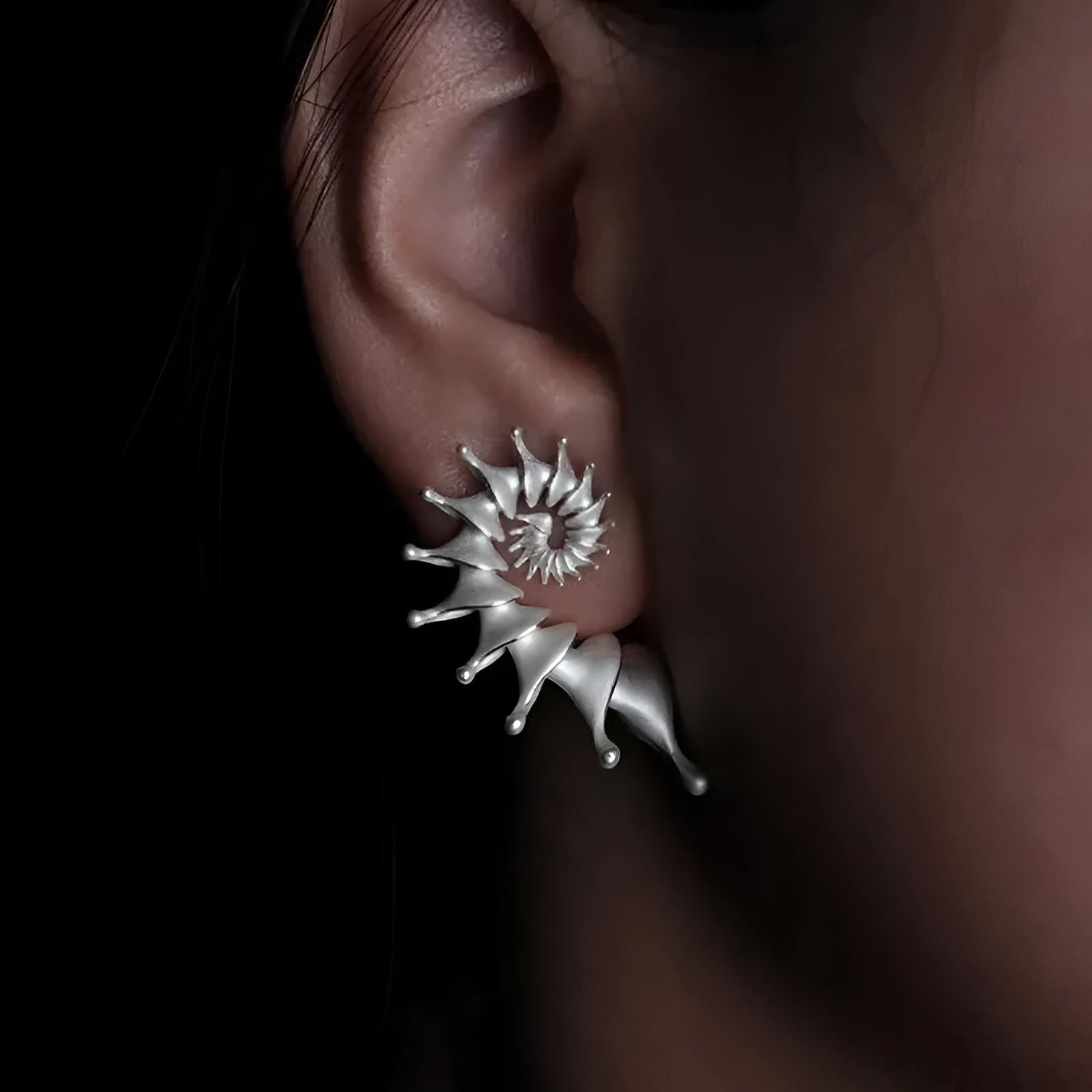 Three-dimensional matte finish conch stud earrings with exaggerated shape and irregular design elements