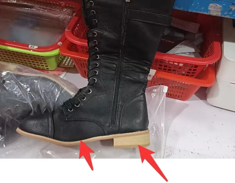 Women's black knight boots with cross-strap design across ankle, mid heel