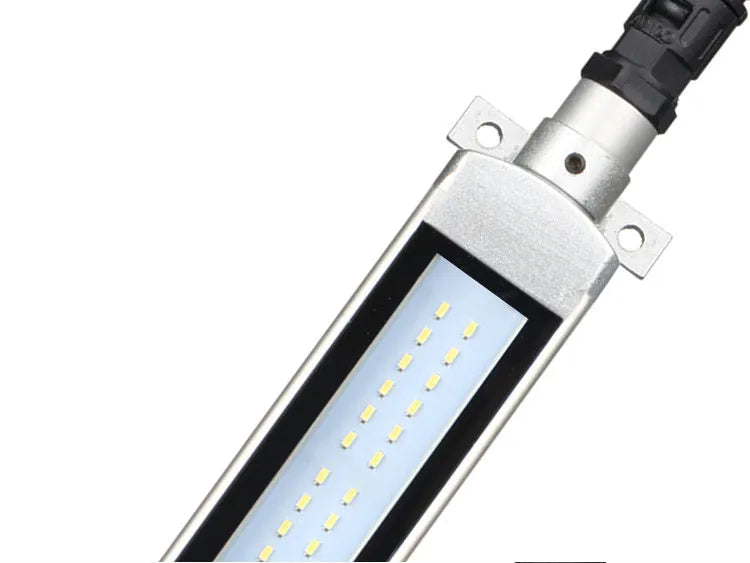 Long, rectangular LED work light with aluminium body and tempered glass front, mounted with a bracket for CNC machine tools.