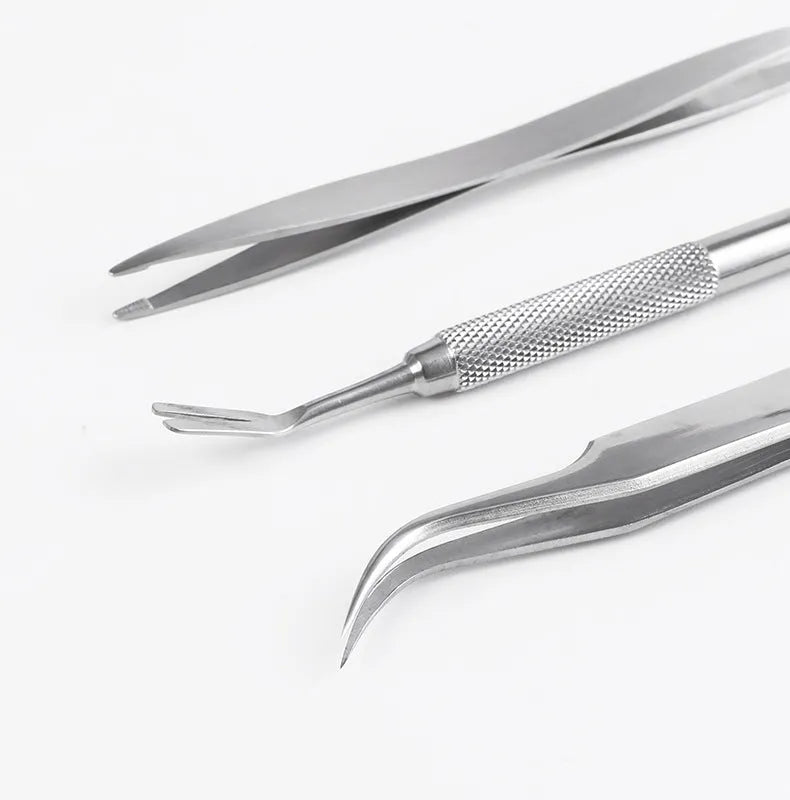 Three silver stainless steel tick clips with grate-style heads for pet parasite removal