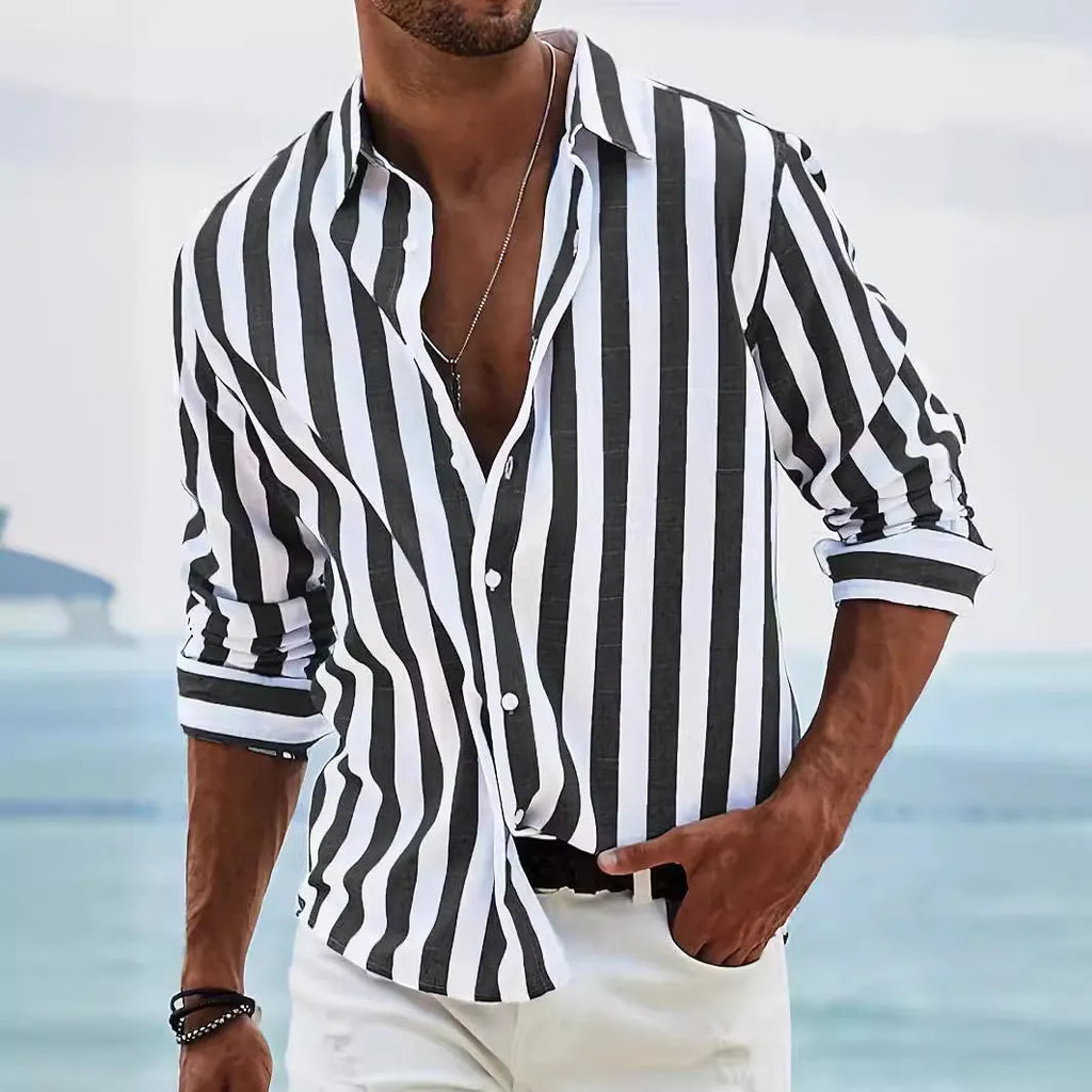 Man wearing a loose-fit, grey and white striped long-sleeved cardigan-style shirt.