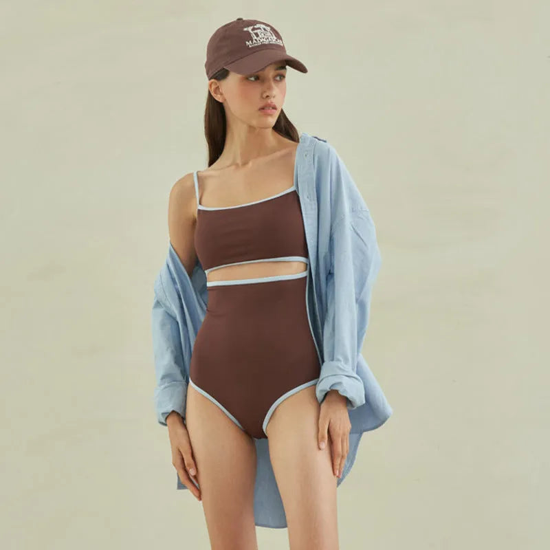 Brown triangle one-piece swimsuit for women on a hanger, showing sexy style and nylon fabric.