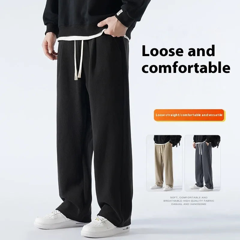 Men's apricot double-sided polar fleece-lined loose fit winter sports trousers on a hanger