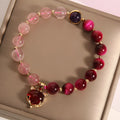 Strawberry crystal bracelet on wrist showing elastic rope construction and natural stone colour