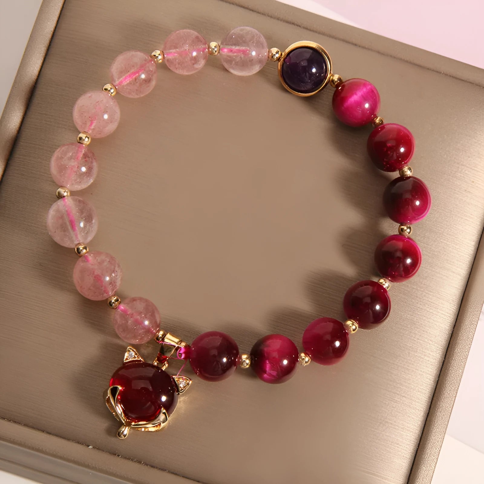 Strawberry crystal bracelet on wrist showing elastic rope construction and natural stone colour