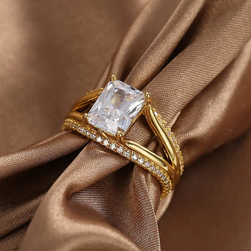 Geometric gold electroplated copper ring for women with a square zircon, shown in sizes 6 to 9.