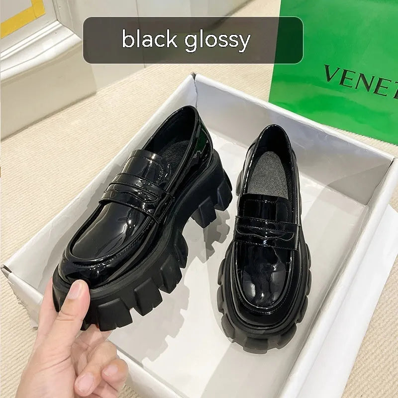 British style wide fat foot loafers in patent leather with a rubber sole.