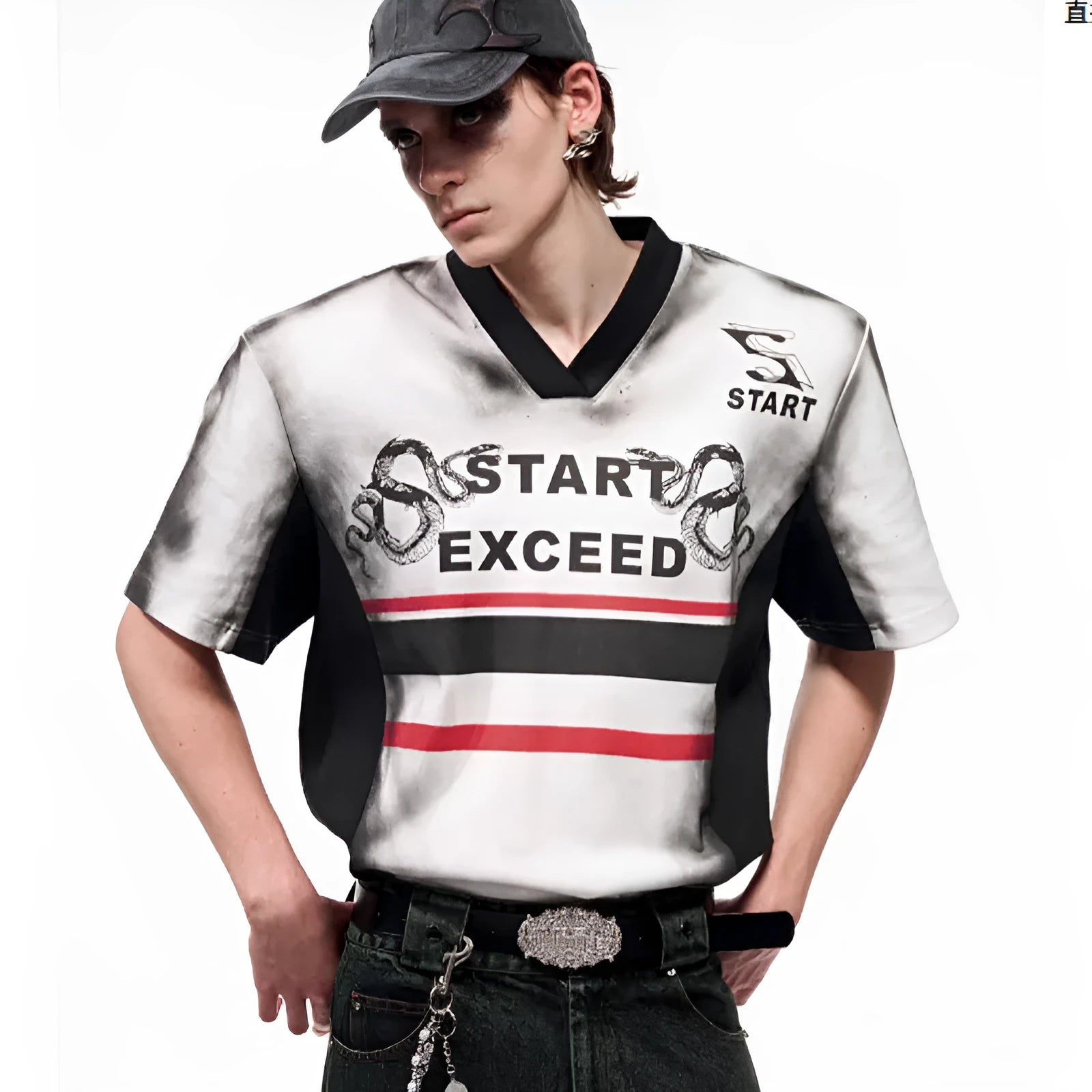 Women's V-neck short sleeve top with snake letter print and padded shoulders on a hanger.