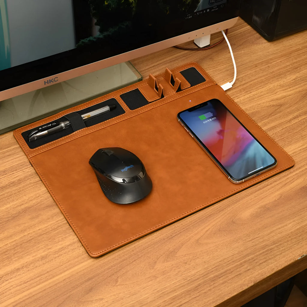 Pink wireless charging mouse pad with phone holder on a wooden desk