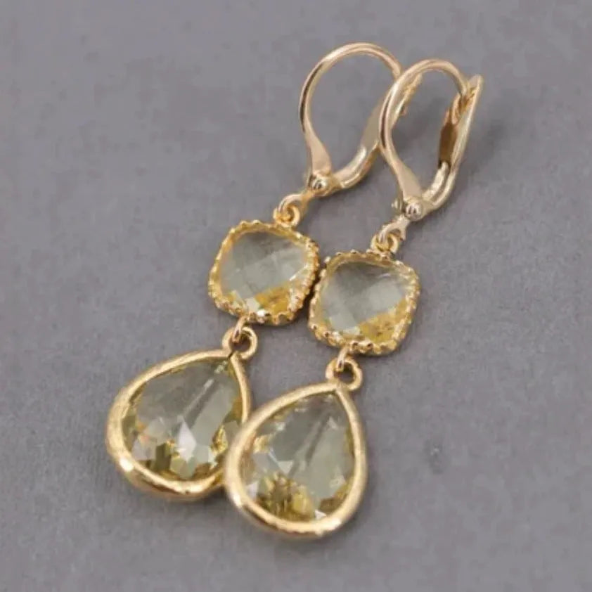 Geometric gold electroplated earrings with long crystal fringe and water droplet elements in retro style