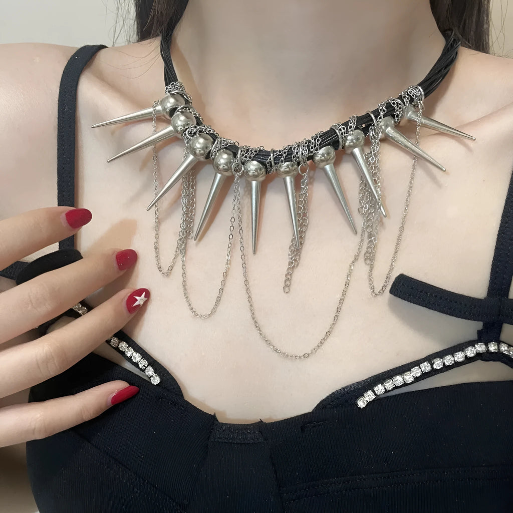 Leather necklace with electroplated rivets, round beads, and a tassel in a winding casual design