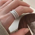 Adjustable opening geometric copper ring with woven twisted multilayer design