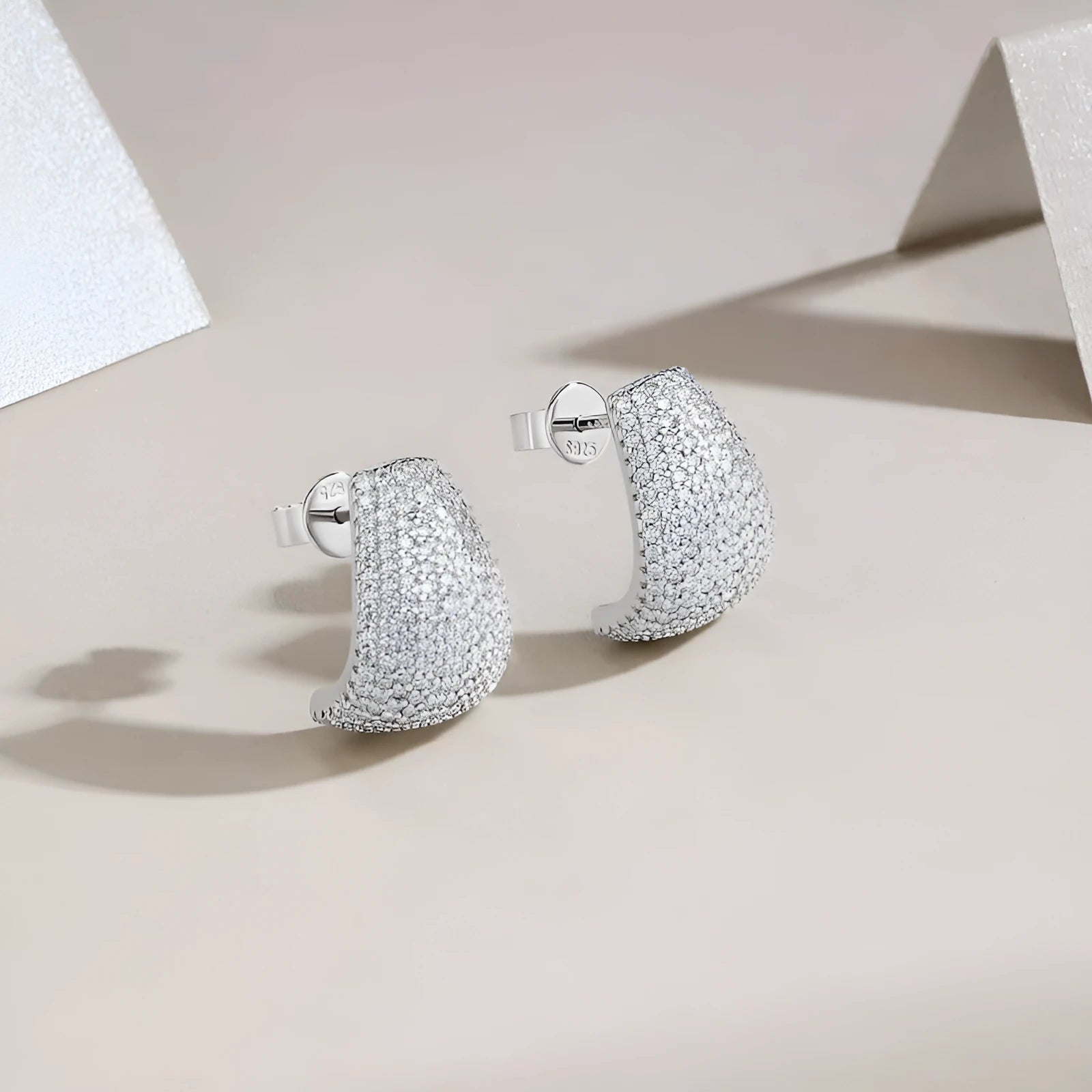 Geometric S925 sterling silver ear studs with colourless moissanite stones in a gift box.