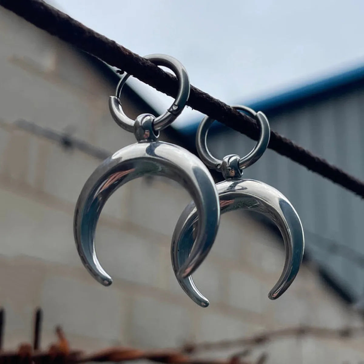 Silver geometric hoop earrings with moon decoration and clip-on fastenings
