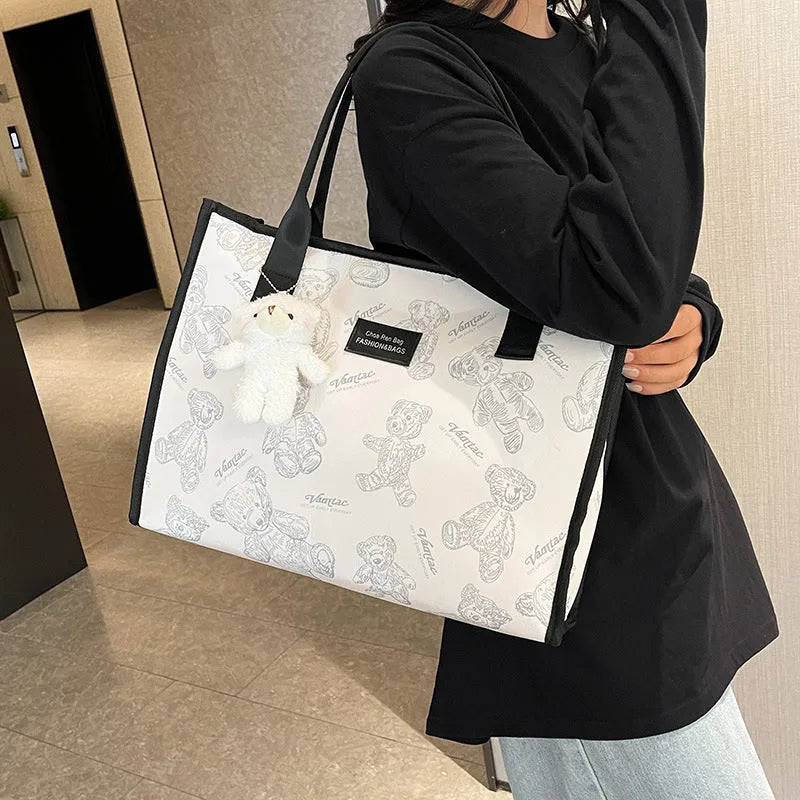 Women's black and white printed canvas tote bag with rhombus pattern and shoulder strap