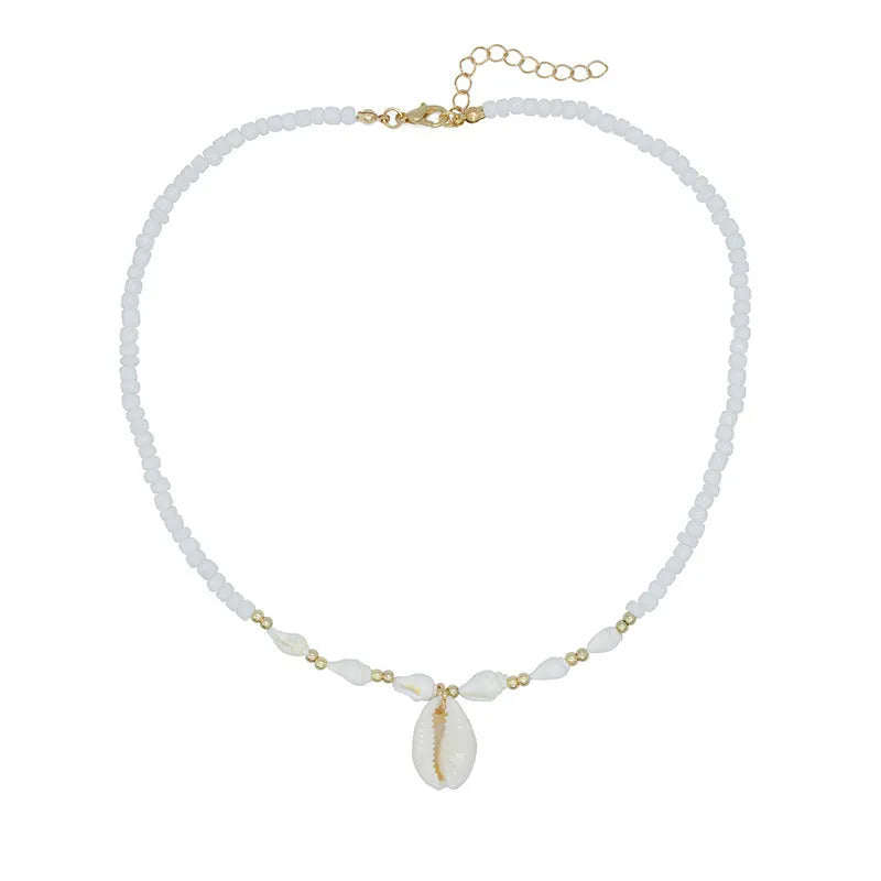 White conch shell pendant necklace with a cold wind pattern design on a silver-toned chain.