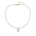 White conch shell pendant necklace with a cold wind pattern design on a silver-toned chain.