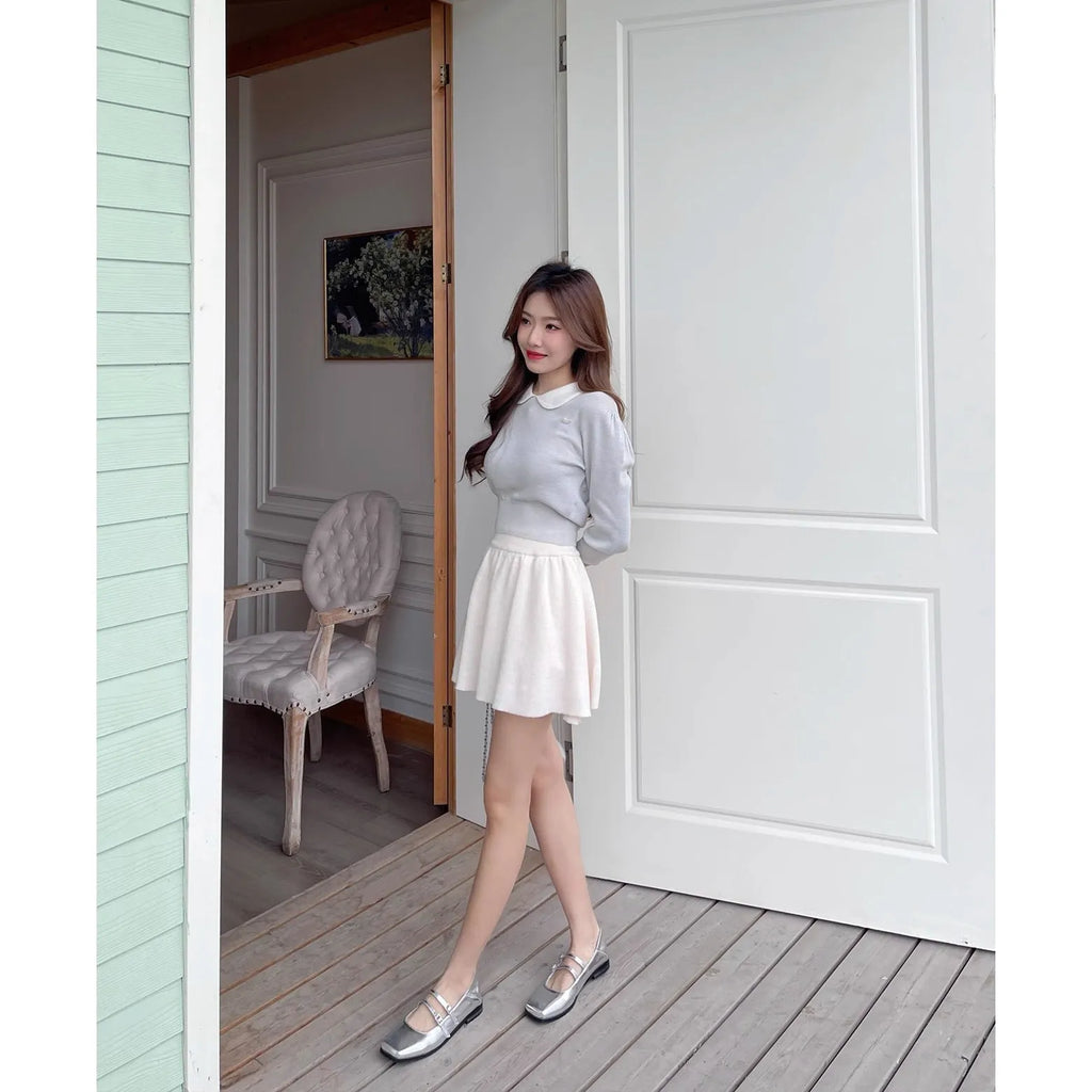 Women's silver genuine sheepskin leather ballet pumps with a cross buckle strap and flat low heel.