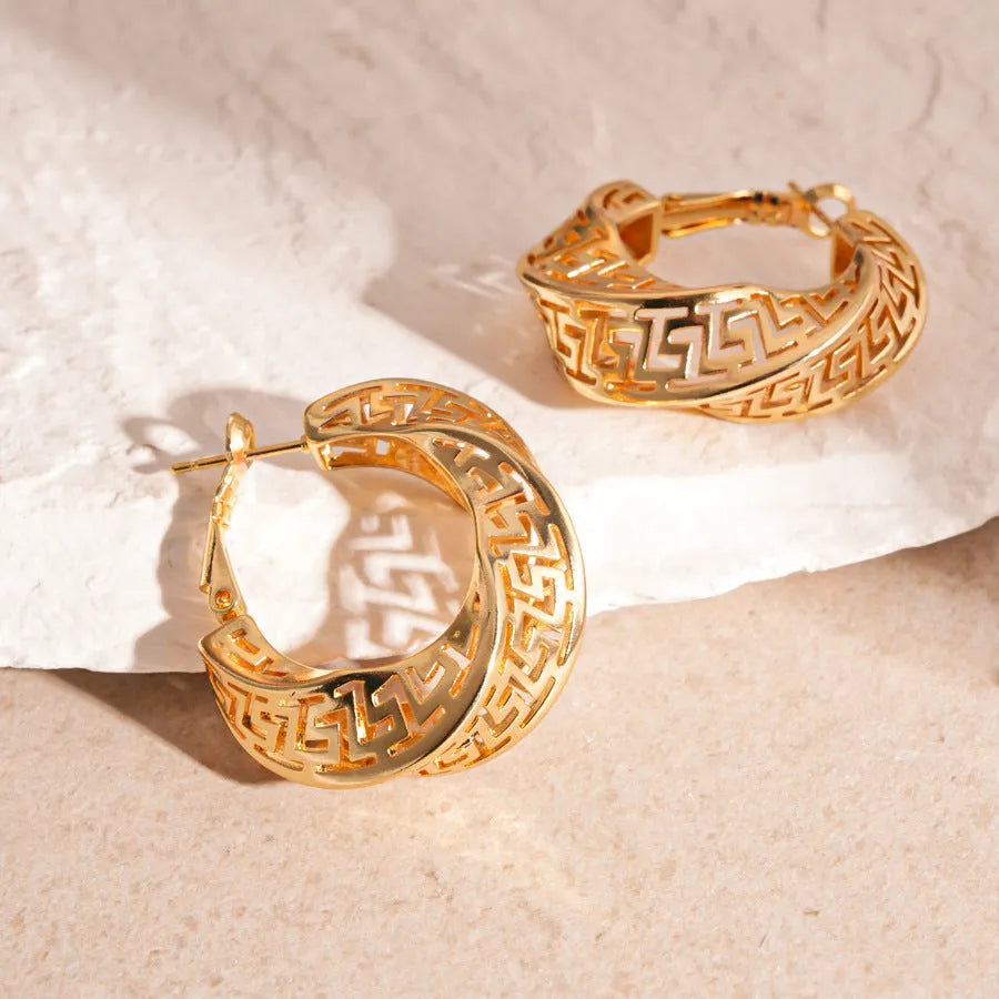 Geometric hollow stud earrings with twisted round design in silver or gold finish