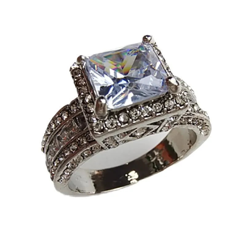 Geometric silver fashion engagement ring for women in gold or white electroplated finish on a size chart.