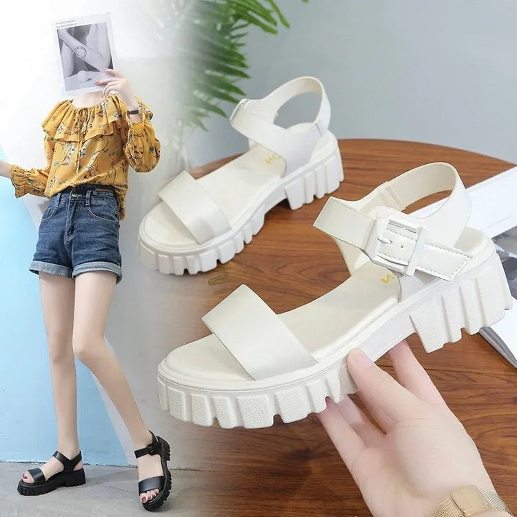 Women's beige peep toe ankle-strap buckle platform sandals with a fish mouth toe design on a wooden surface.