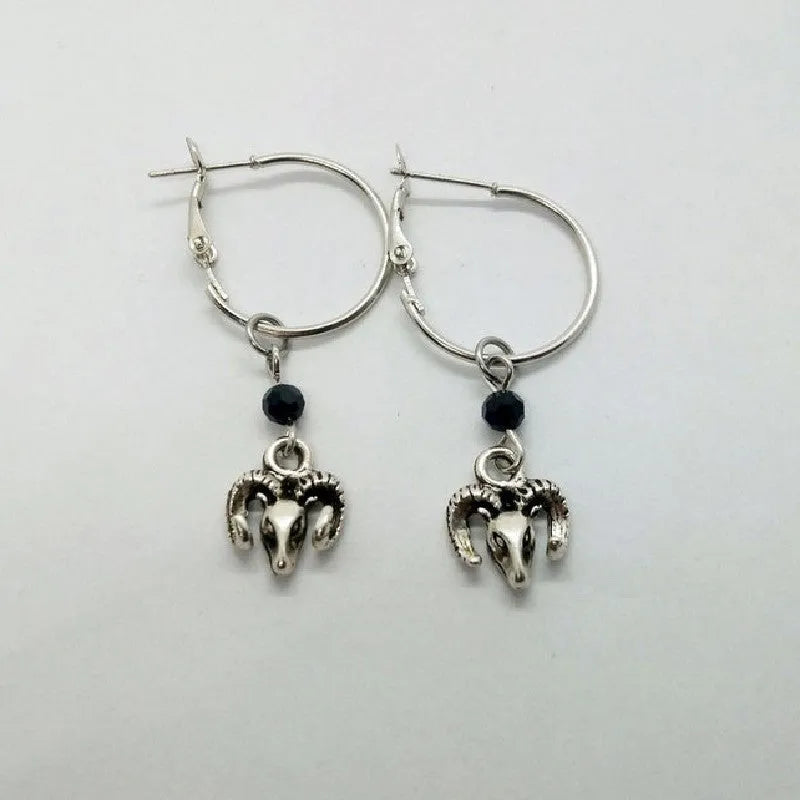 Silver round hoop earrings with a Tibetan antelope design motif for women.