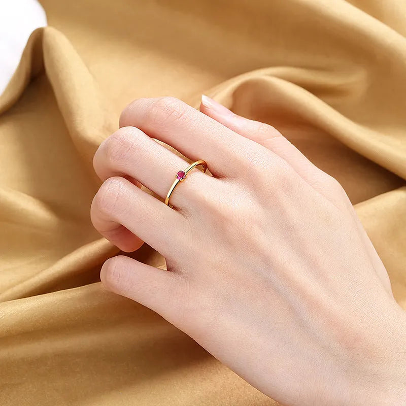 Women's copper geometric circle ring with a single round diamond, shown in multiple colour options.