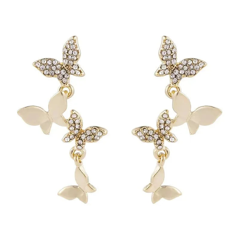 Gold colour butterfly earrings with four copper charms on hanging ear drops