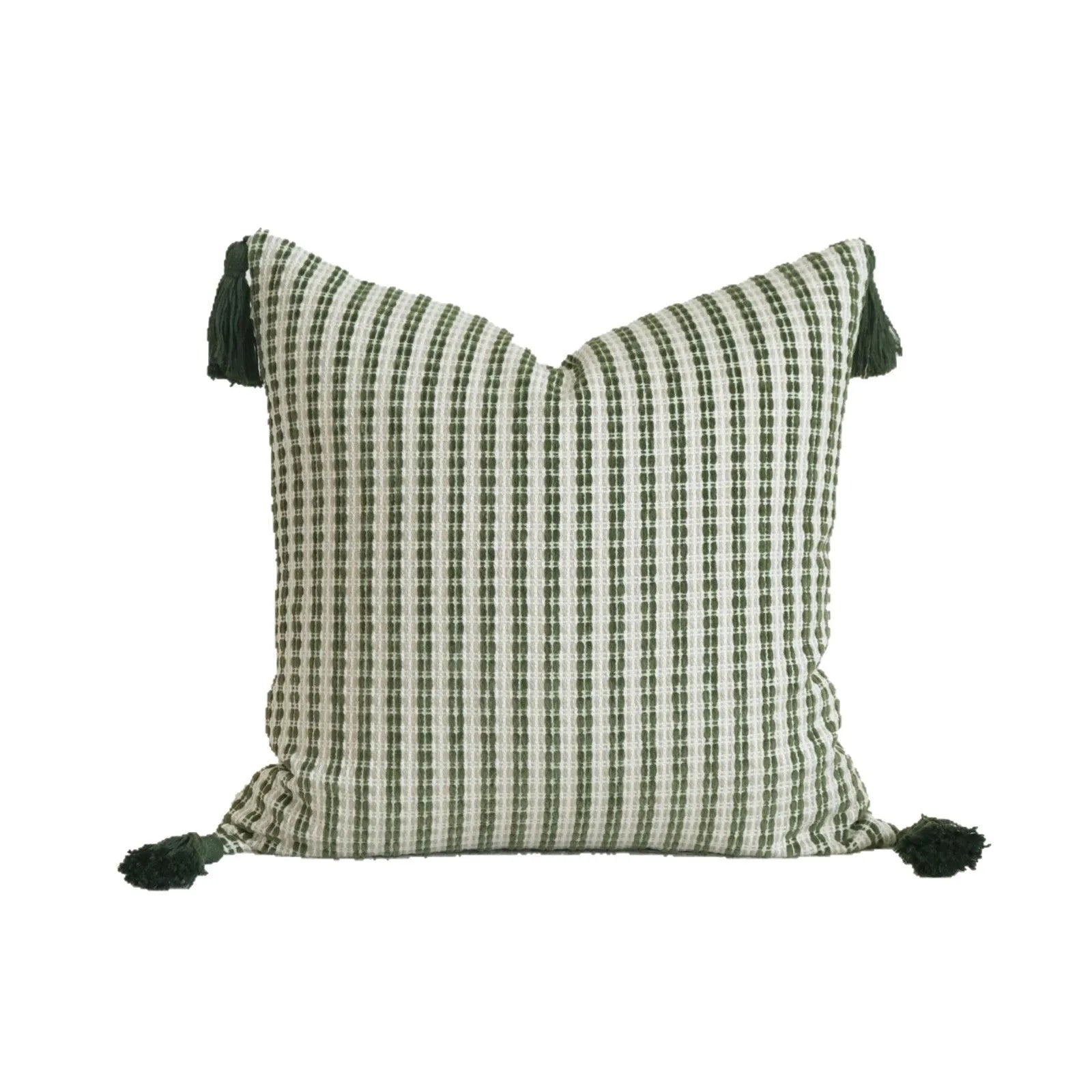 Green cotton linen hotel sample pillow with tassel design and silk floss filling on bed.