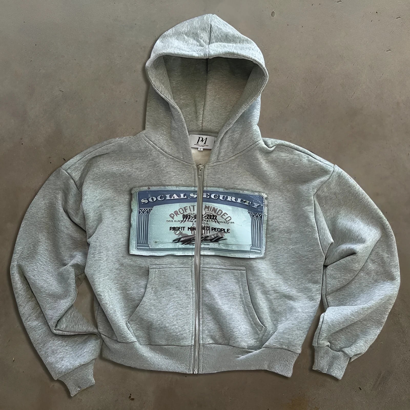 Black loose-fit hoodie zipper jacket with letter pattern and zipper pockets laid flat.