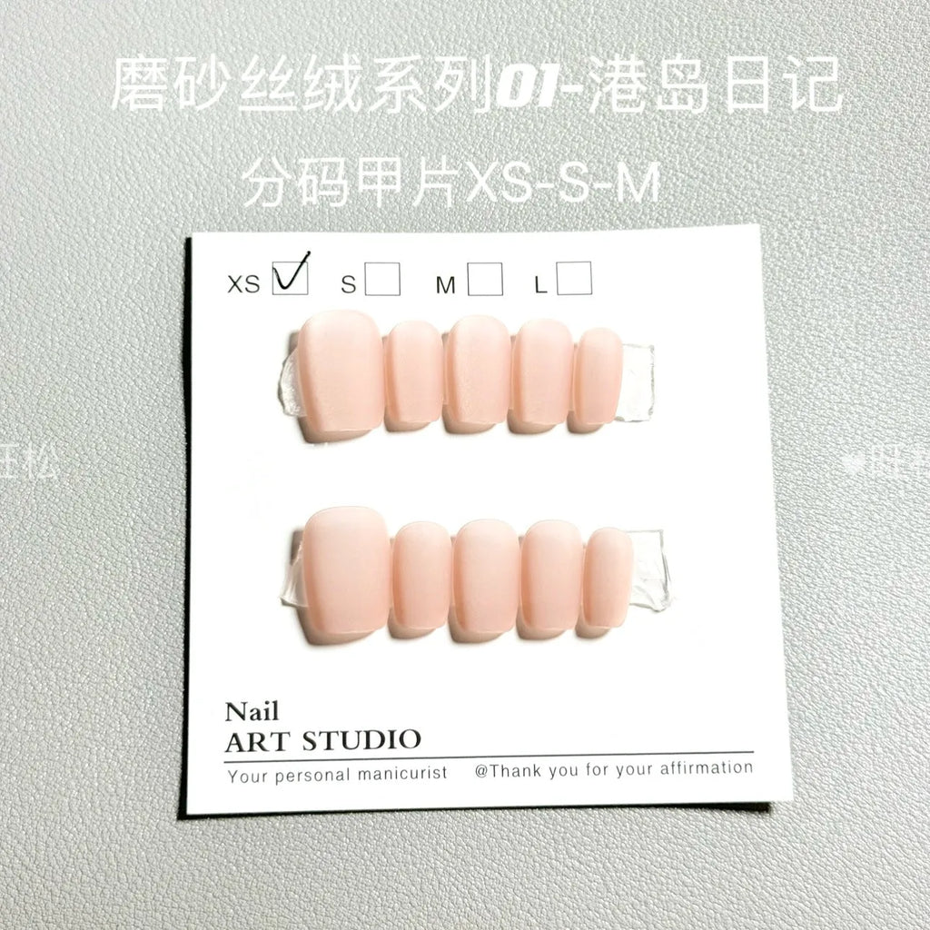 Set of frosted velvet cat's eye effect artificial nails in short ladder shapes on a clear background.