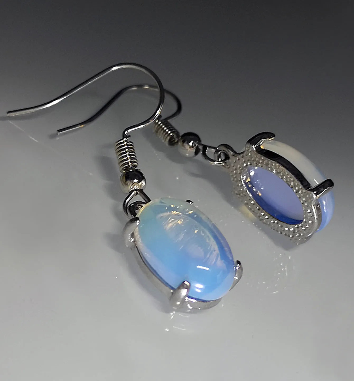 Moonlight White opal earrings with electroplated alloy construction in drop shape design