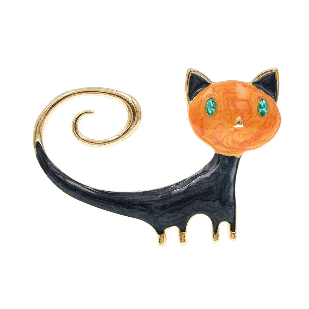 Close-up of a white alloy brooch shaped like a cat with an orange painted tail.