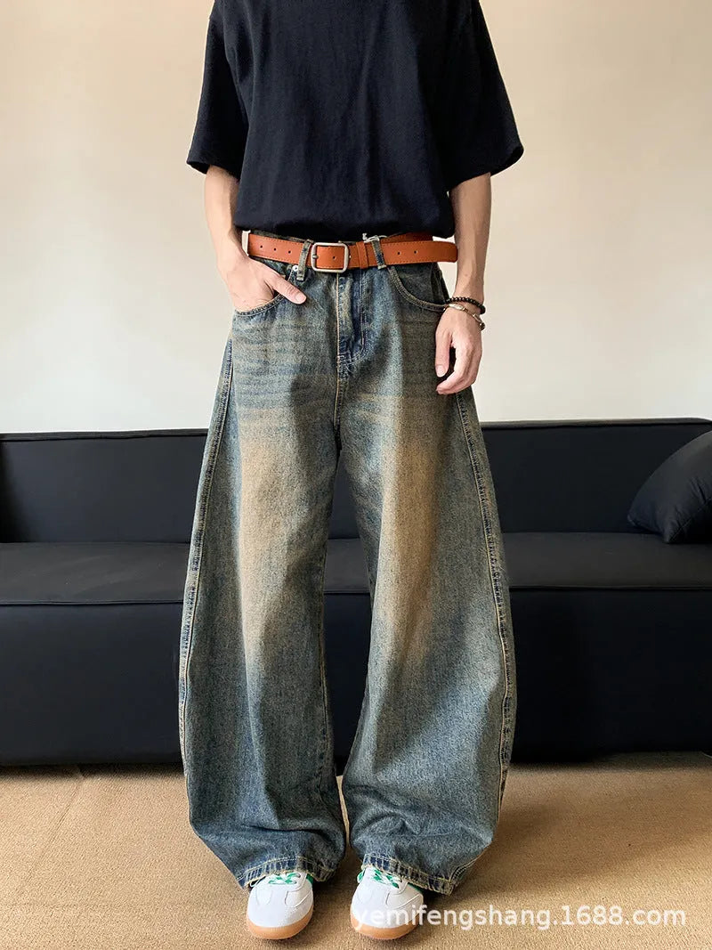 Retro blue distressed machete denim jeans for men with a wide-leg slim cut.