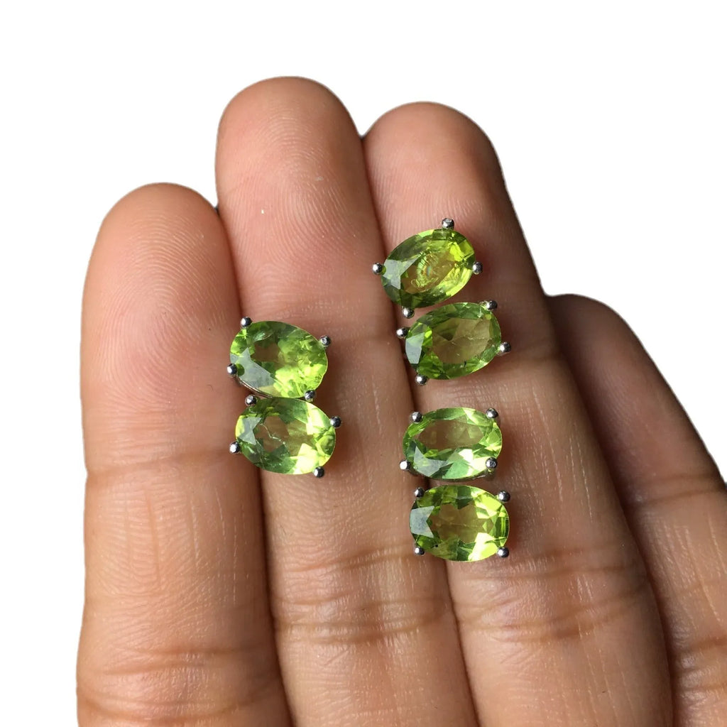 Natural grass green olivine faceted stud earrings set in S925 silver, showing oval stone shape.