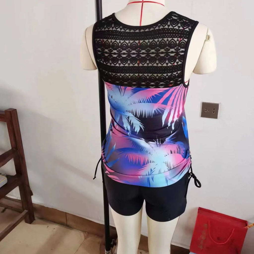 Women's blue two-piece swimsuit with floral lace print, showing top and briefs.