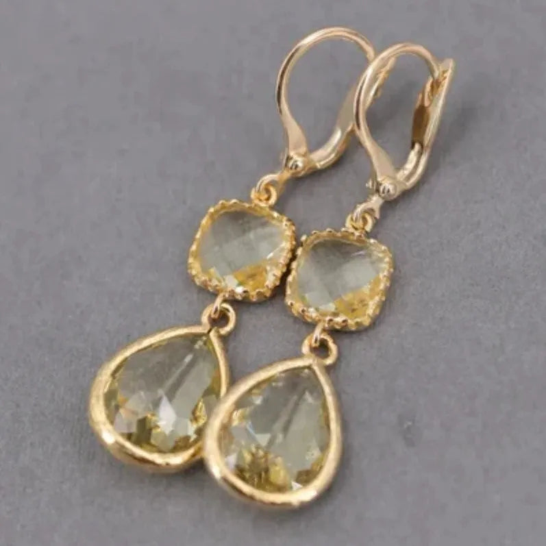 Geometric gold electroplated earrings with long crystal fringe and water droplet elements in retro style