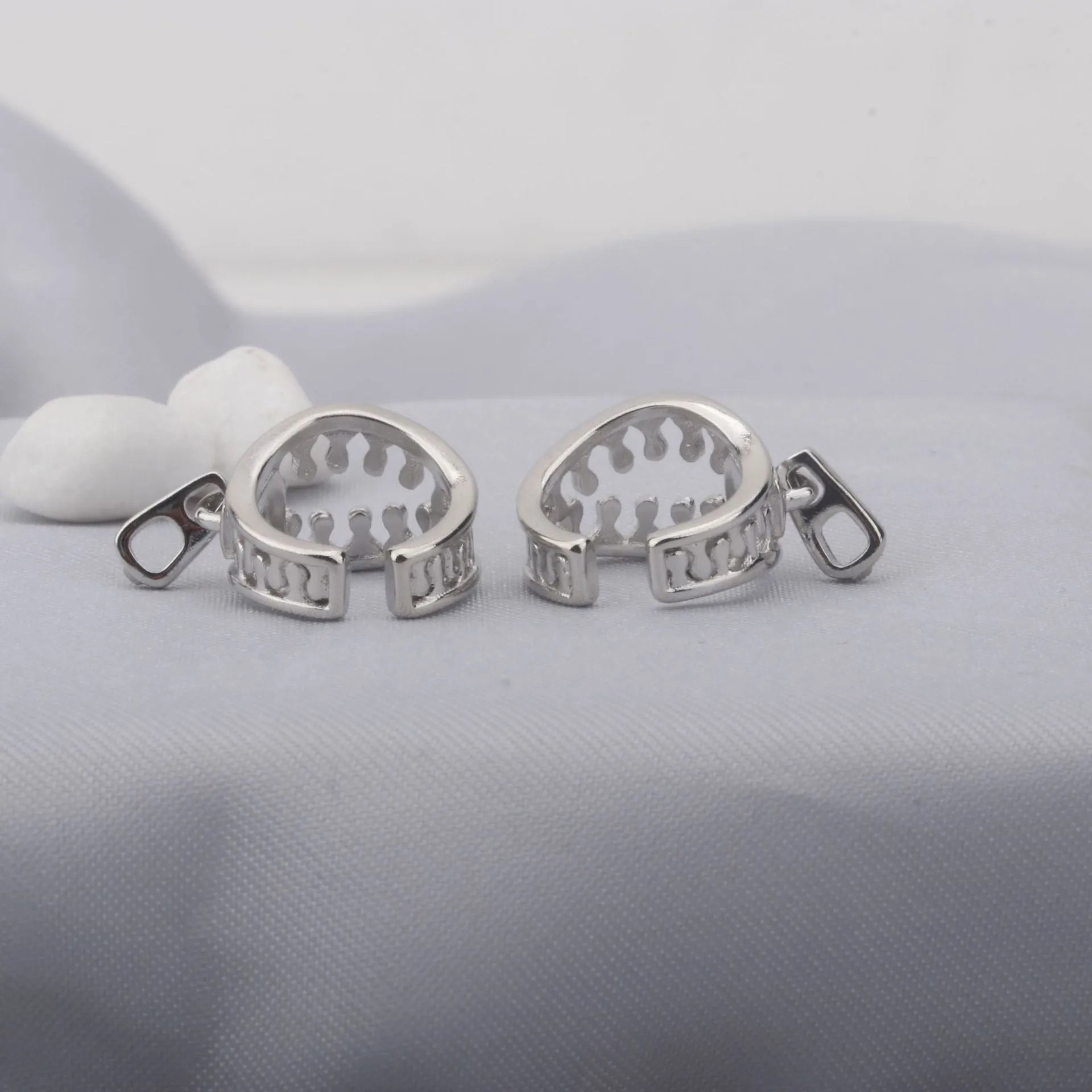 Copper geometric ear clips with zipper design detail in ES862 colour showing bone clip fastening