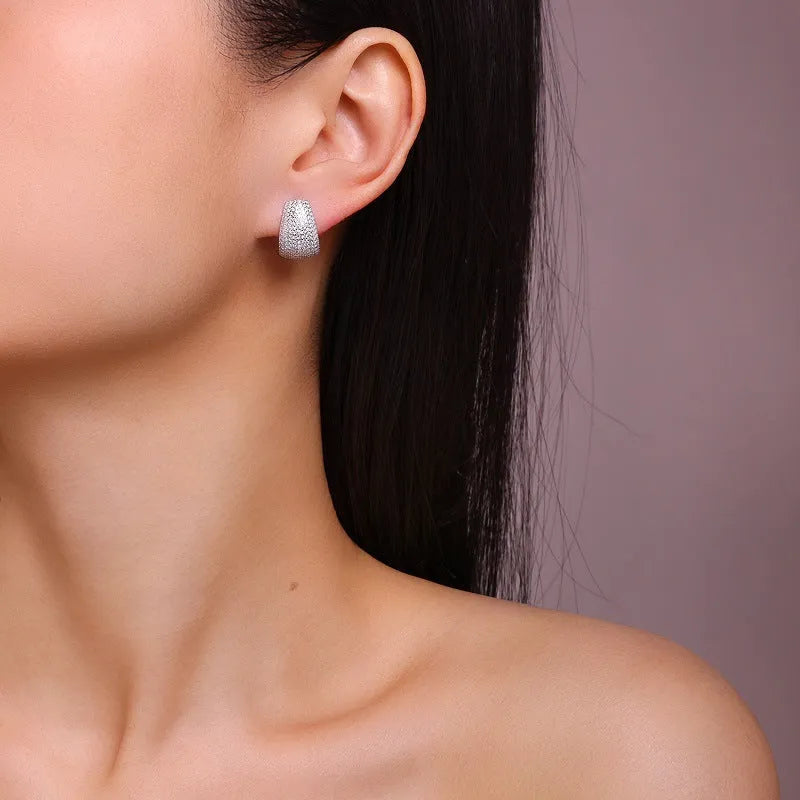 Geometric S925 sterling silver ear studs with colourless moissanite stones in a gift box.