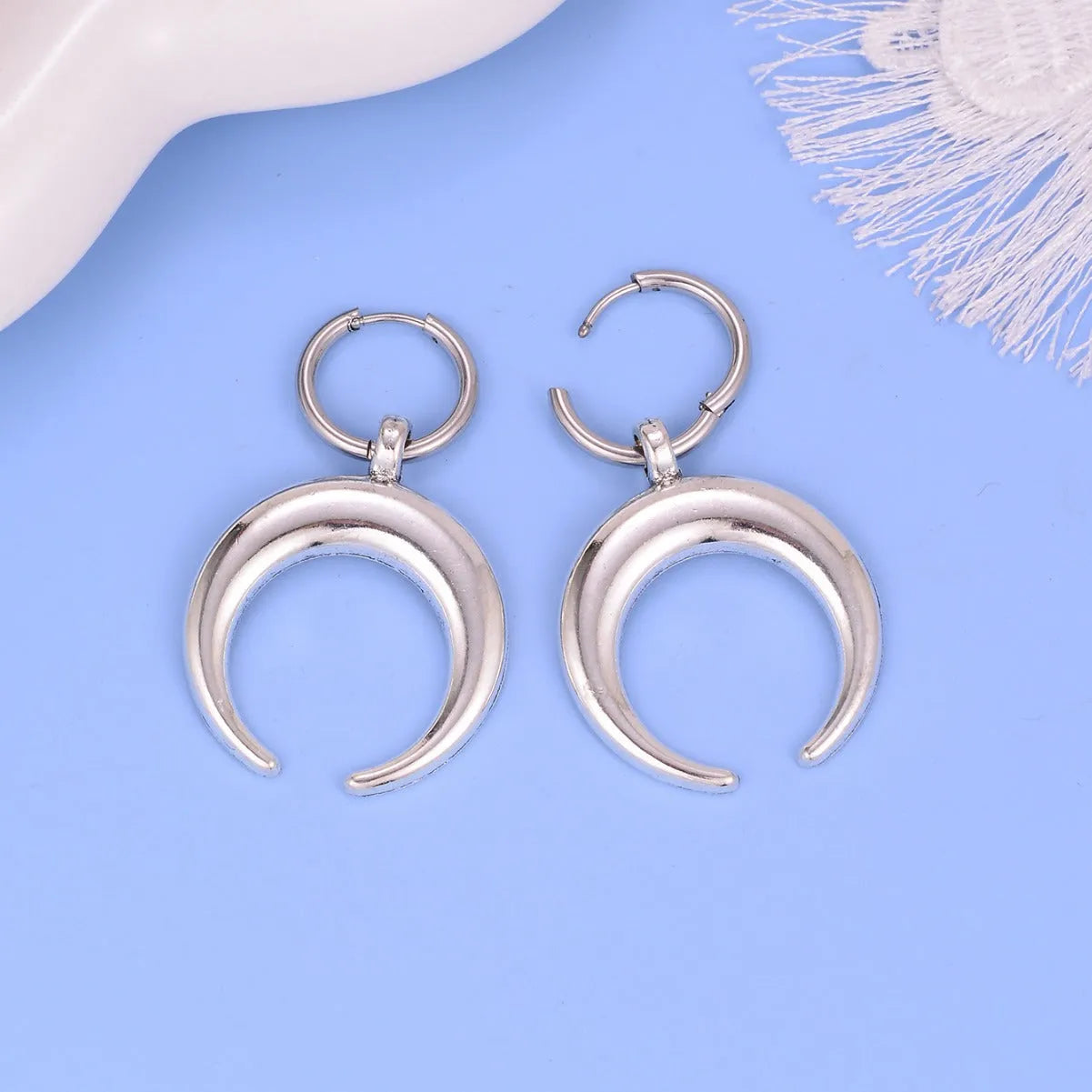 Silver geometric hoop earrings with moon decoration and clip-on fastenings