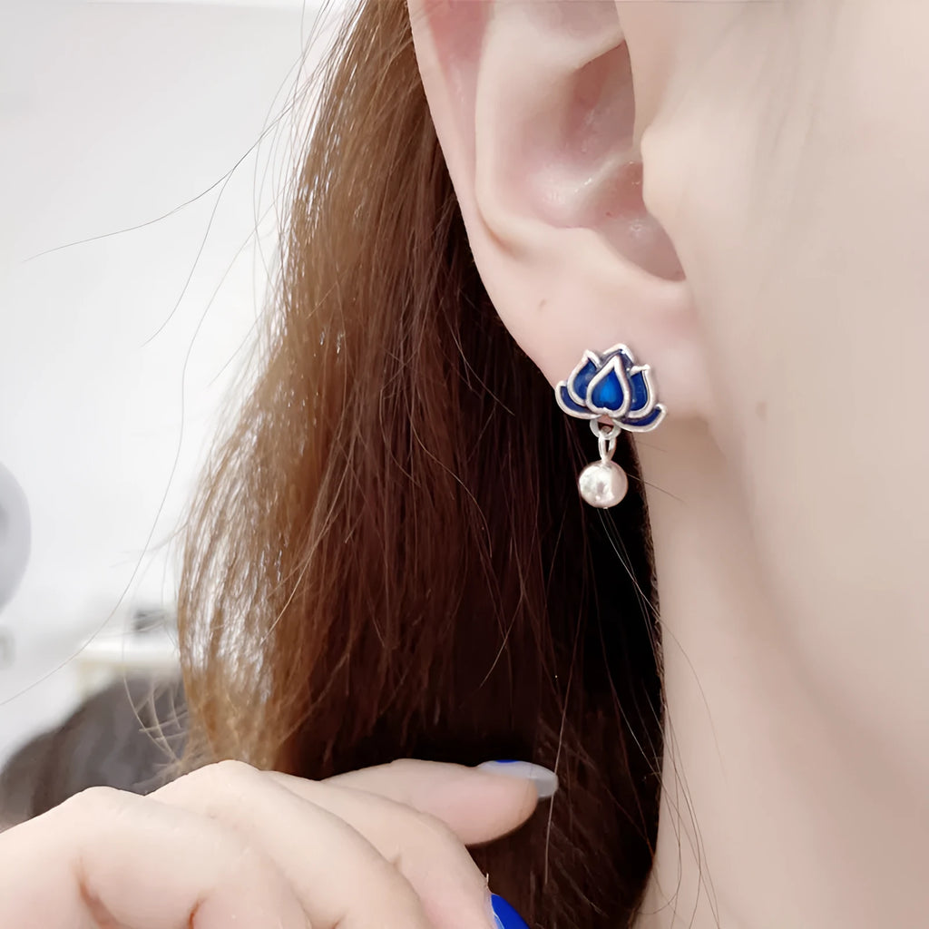 Close-up of alloy lotus ear studs with silver needle seedpod tassel design, showing 1.2cm width.