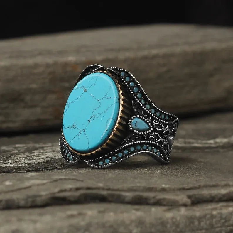 Men's antique silver turquoise ring showing round shape and polished metallic finish