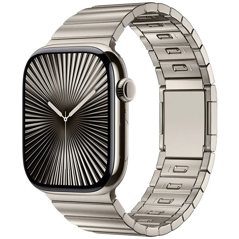 Stainless steel magnetic buckle Apple Watch replacement band in silver colour on a wrist.