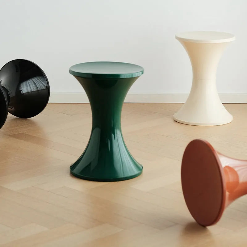 A plastic hourglass-shaped shoe changing stool in one of five colour options.