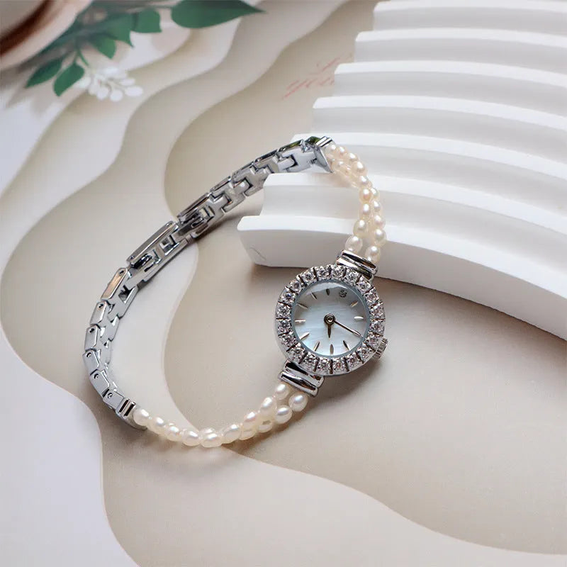 Women's light gold bracelet watch with freshwater pearls, 18mm round dial, single folding buckle