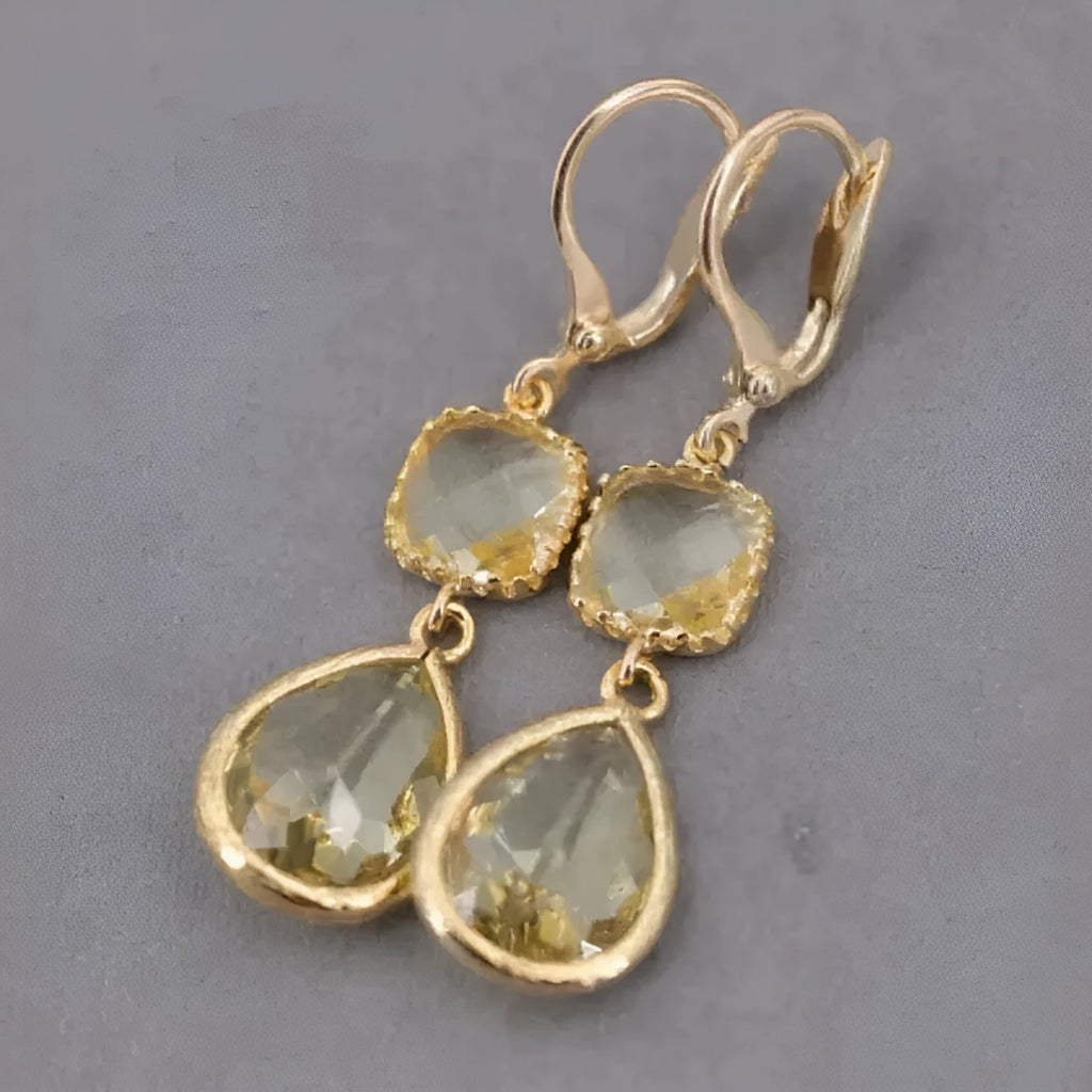 Geometric gold electroplated earrings with long crystal fringe and water droplet elements in retro style
