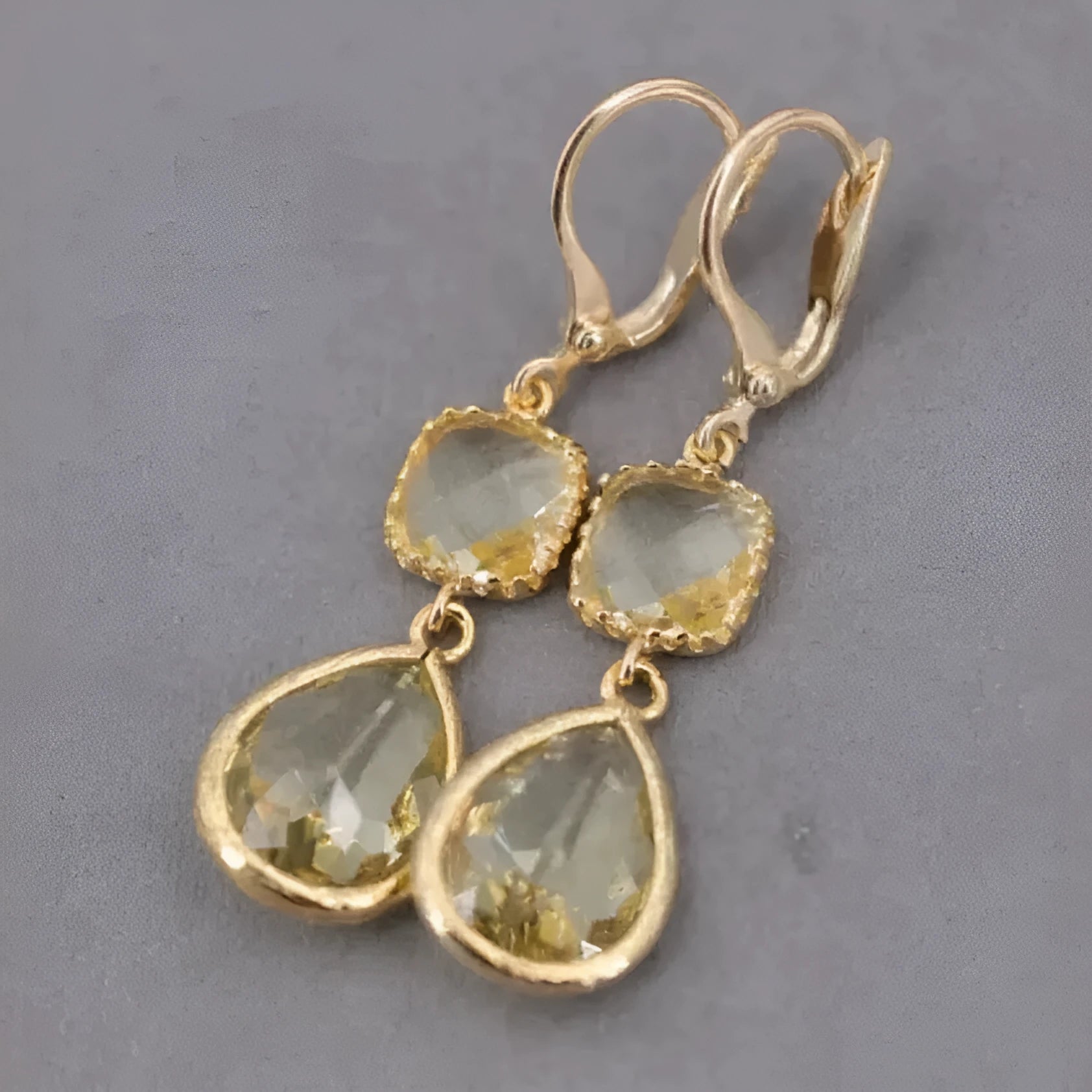 Geometric gold electroplated earrings with long crystal fringe and water droplet elements in retro style