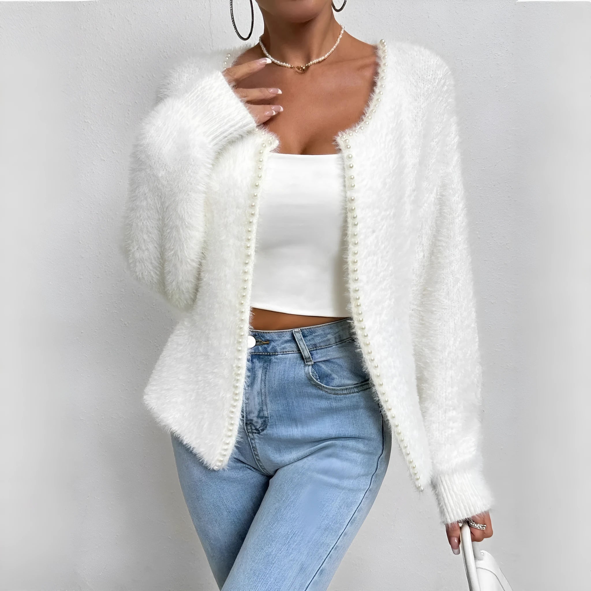 White women's V-neck cardigan sweater with bead knit texture on a hanger.